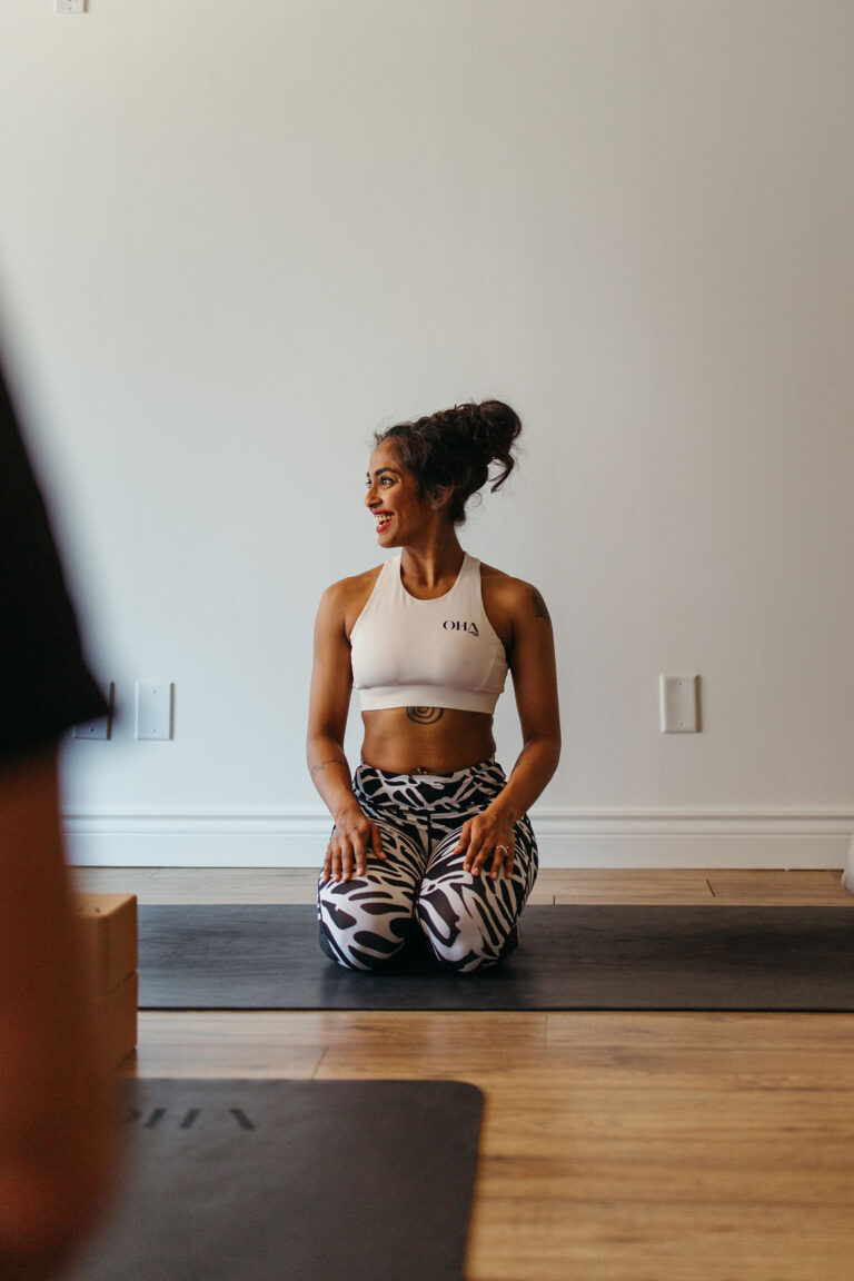 Yoga instructor at OHA Wellness in Liberty Village, Toronto, preparing for a yoga, pilates, or meditation session in a peaceful studio setting.